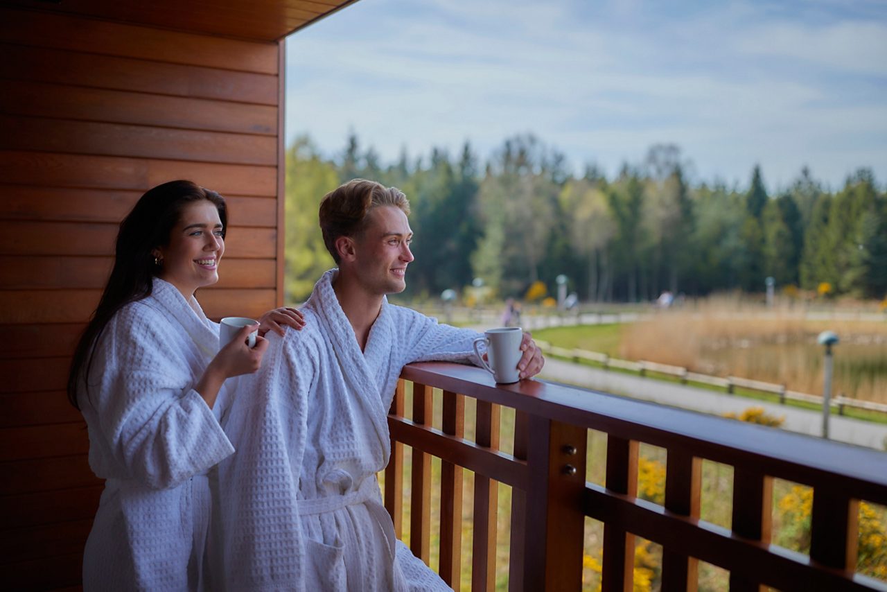 couple on the apartment balcony looking at the view